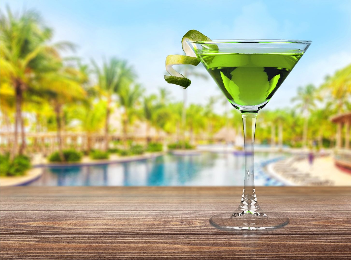 Apple Martini in front of tropical background