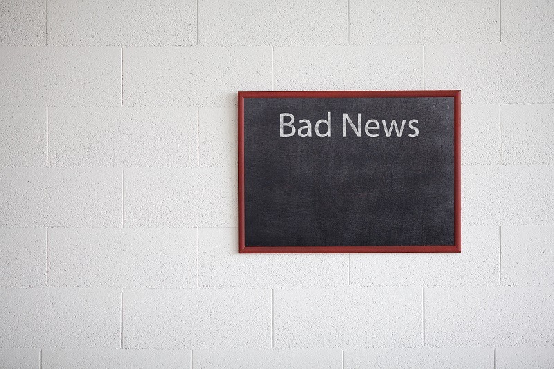Bad news written on a chalkboard