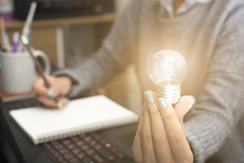 Woman holding light bulb in hand