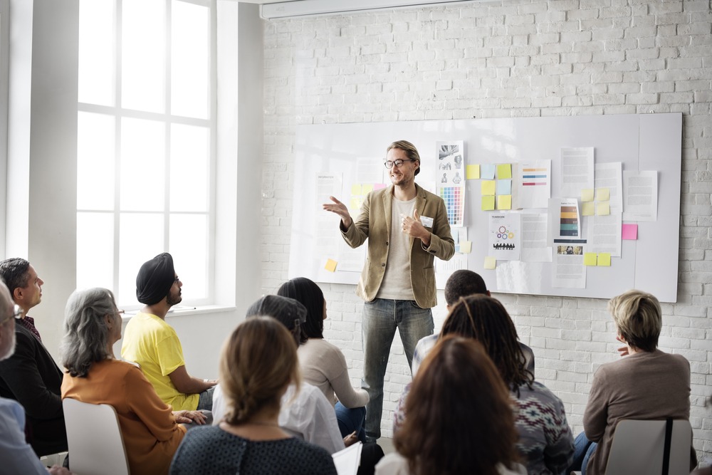 People listening to a trainer give a presentation