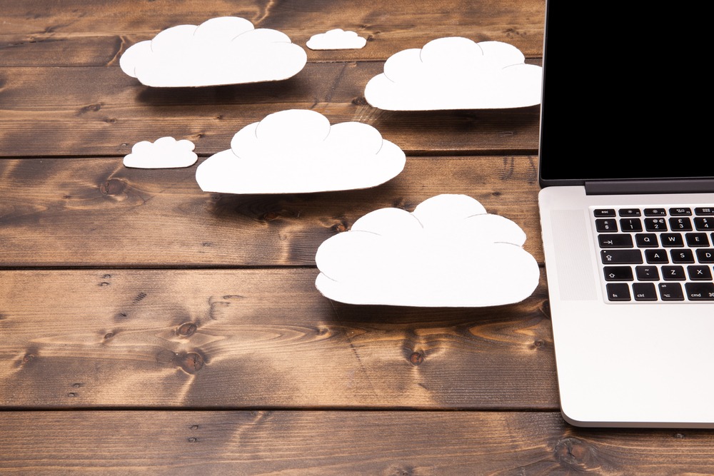 Laptop close up with white clouds coming